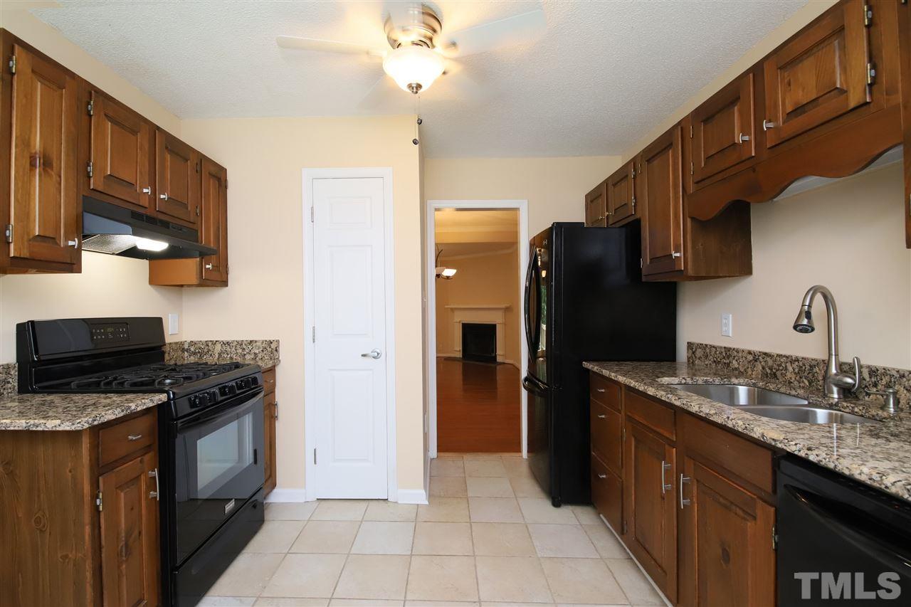 6708 Chauncey Drive Raleigh, NC 27615 - Photo 3 of 25 a kitchen with stainless steel appliances granite countertop a refrigerator a stove and a sink