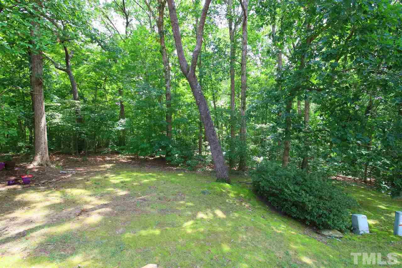6708 Chauncey Drive Raleigh, NC 27615 - Photo 22 of 25 a view of a yard with a trees