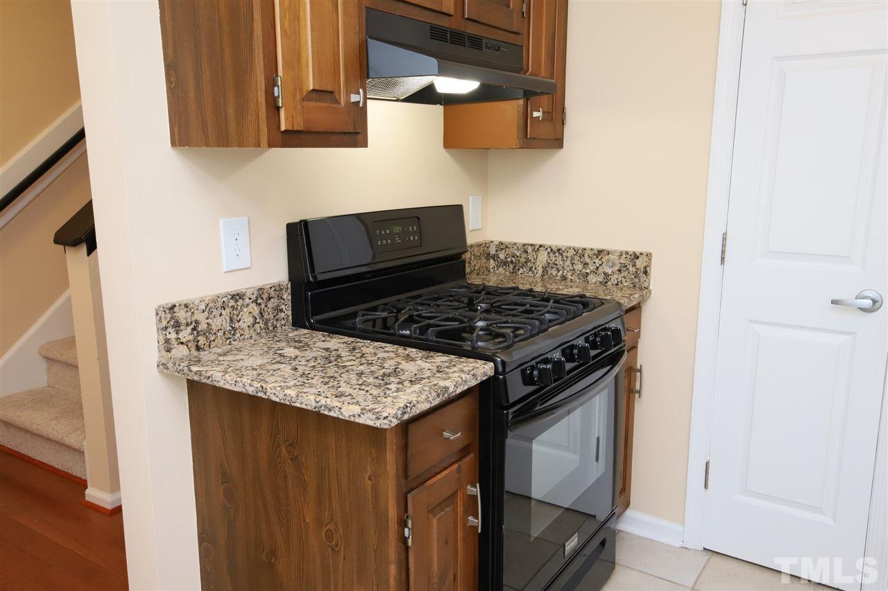 6708 Chauncey Drive Raleigh, NC 27615 - Photo 5 of 25 a kitchen with stainless steel appliances granite countertop a stove and a sink