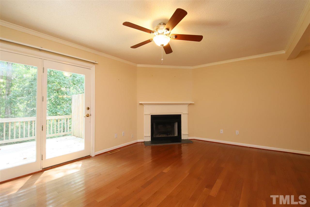 6708 Chauncey Drive Raleigh, NC 27615 - Photo 6 of 25 a view of an empty room with wooden floor and a window