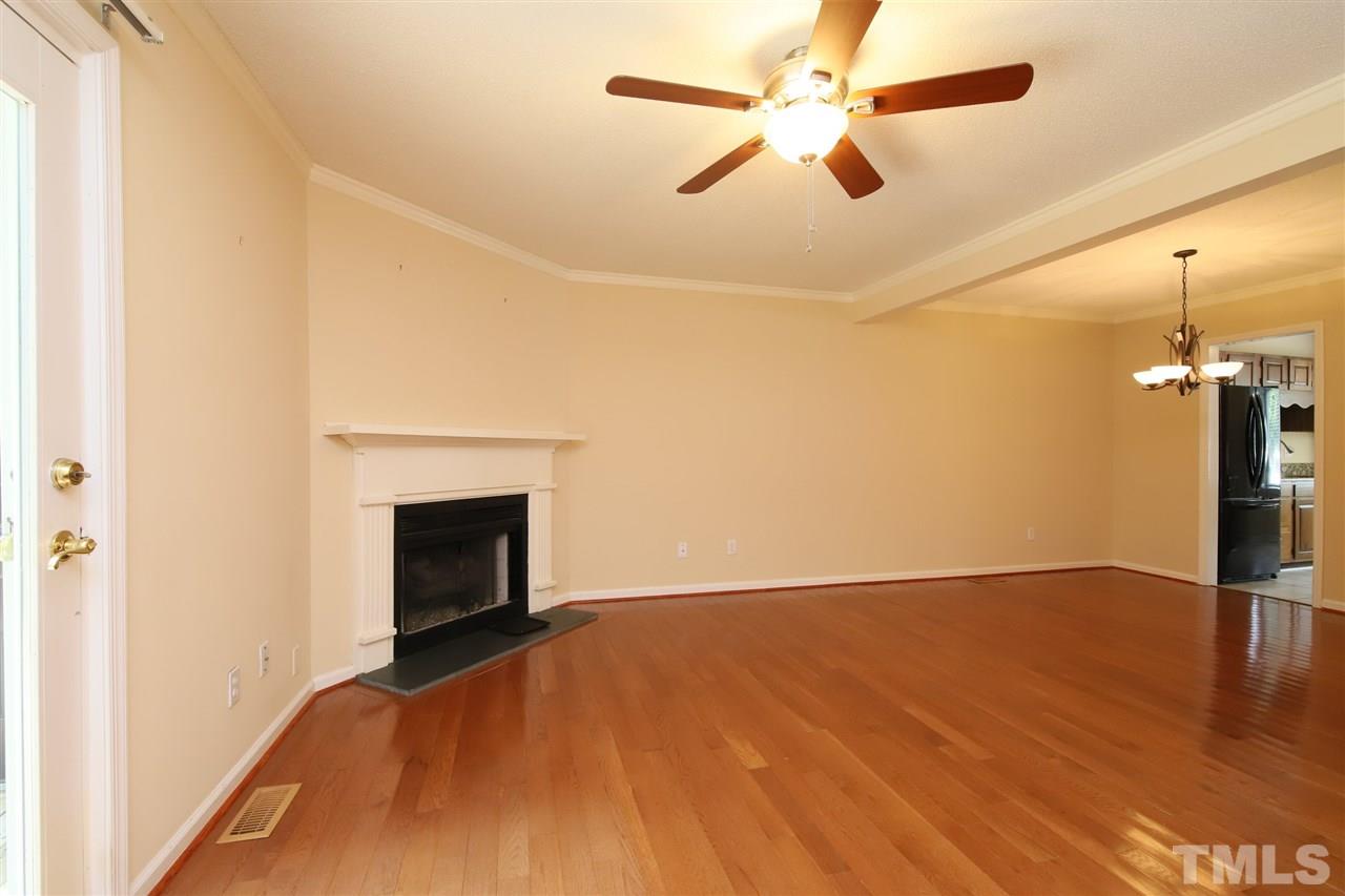 6708 Chauncey Drive Raleigh, NC 27615 - Photo 7 of 25 a view of empty room with wooden floor and fan