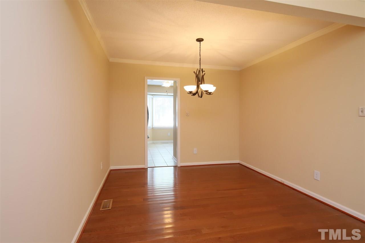 6708 Chauncey Drive Raleigh, NC 27615 - Photo 9 of 25 a view of empty room with wooden floor and fan