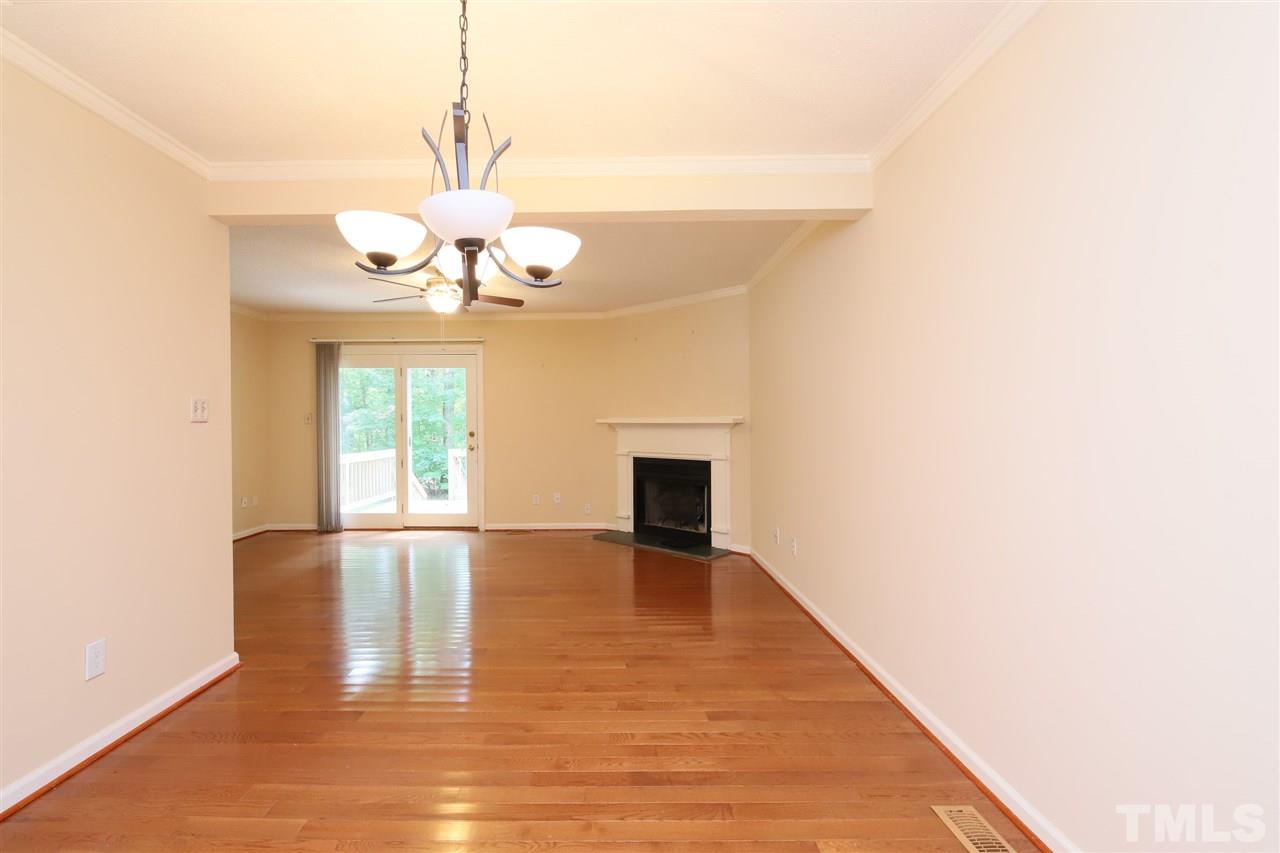 6708 Chauncey Drive Raleigh, NC 27615 - Photo 10 of 25 a view of an empty room with a window and wooden floor