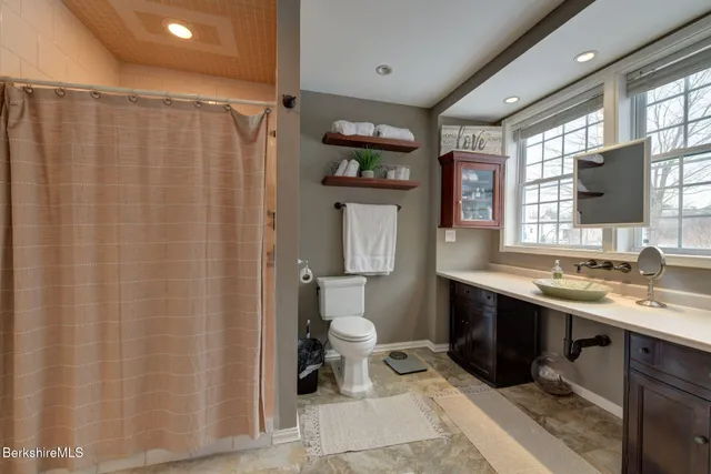 a bathroom with a sink toilet and shower