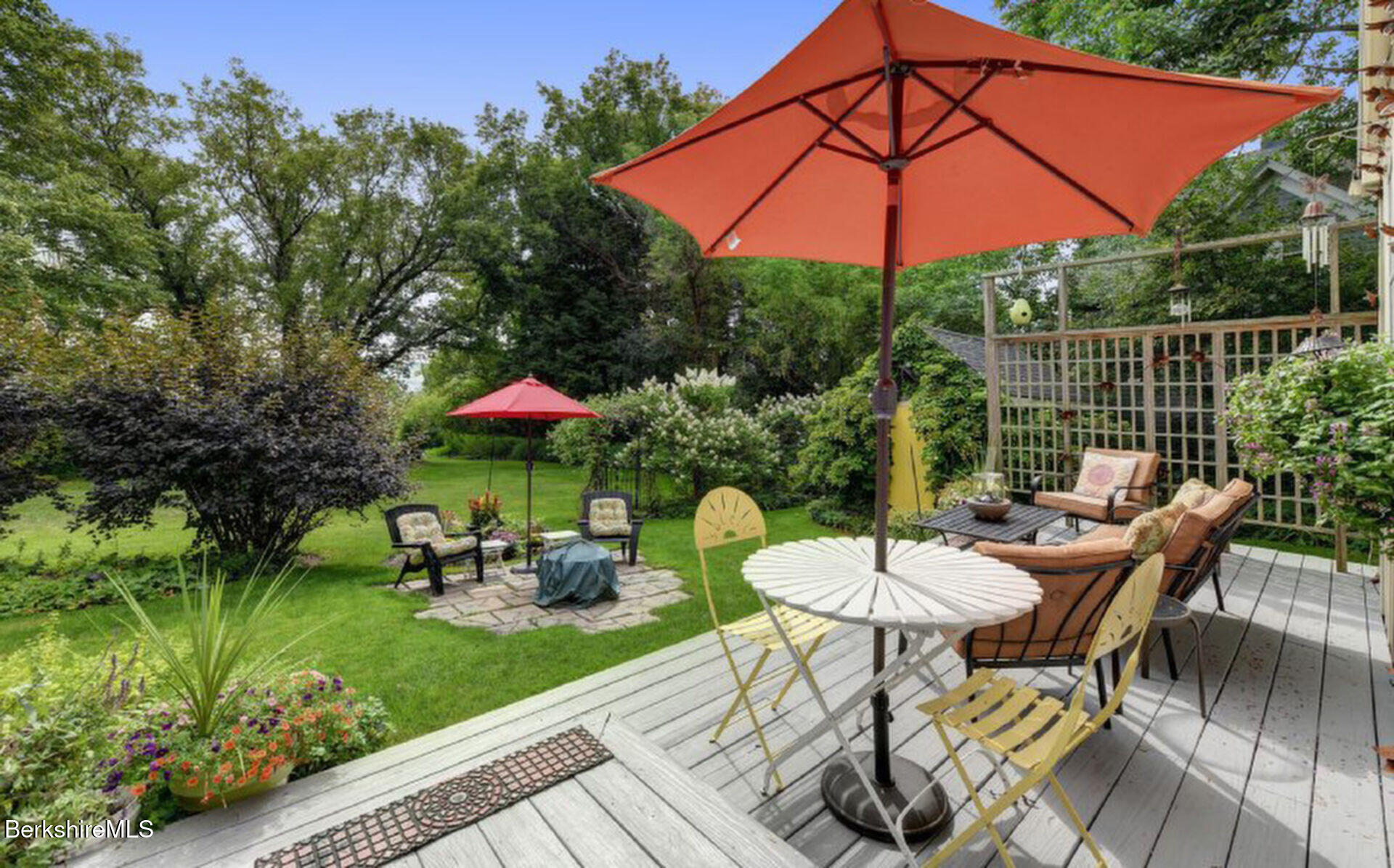 43 Chapman Road Pittsfield, MA 01201 - Photo 24 of 26 a patio with a table and chairs under an umbrella