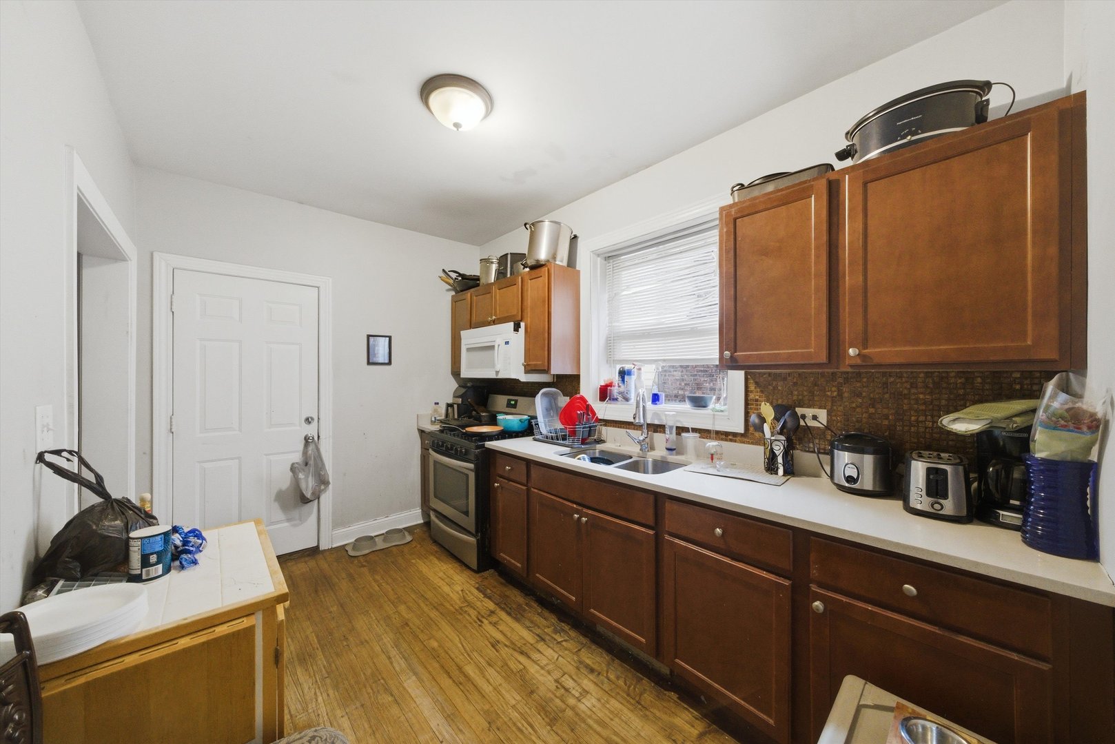 6837 South Morgan Street Chicago, IL 60621 - Photo 12 of 24 a kitchen with a sink and cabinets