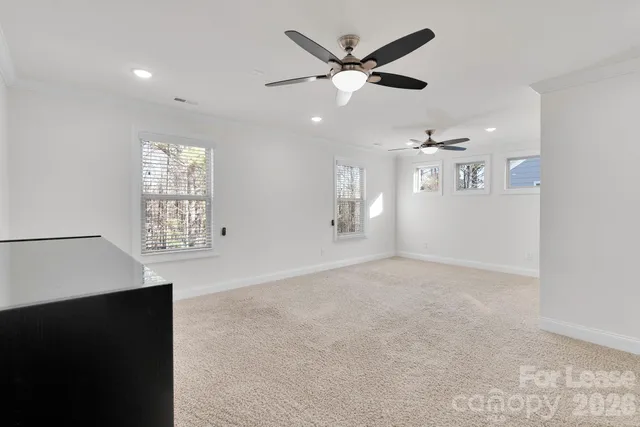 a view of an empty room with a ceiling fan