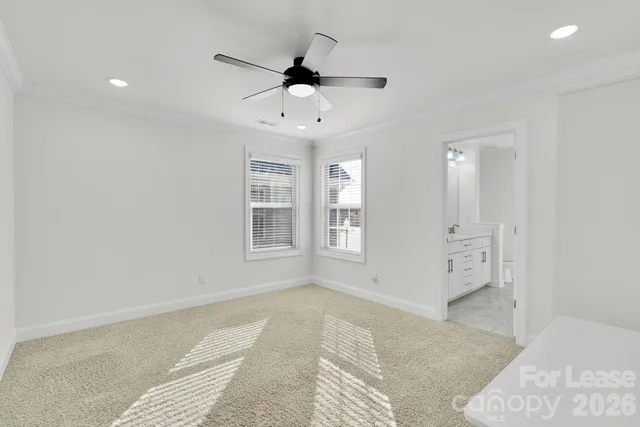 a bedroom with a bed and a ceiling fan