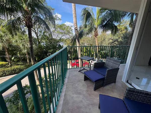 a view of a balcony with outdoor seating