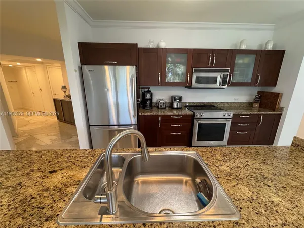a kitchen with a sink stove and refrigerator