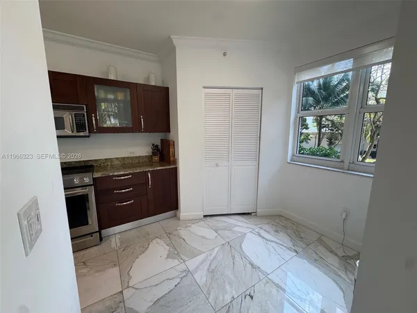 a bedroom with a dresser and a window