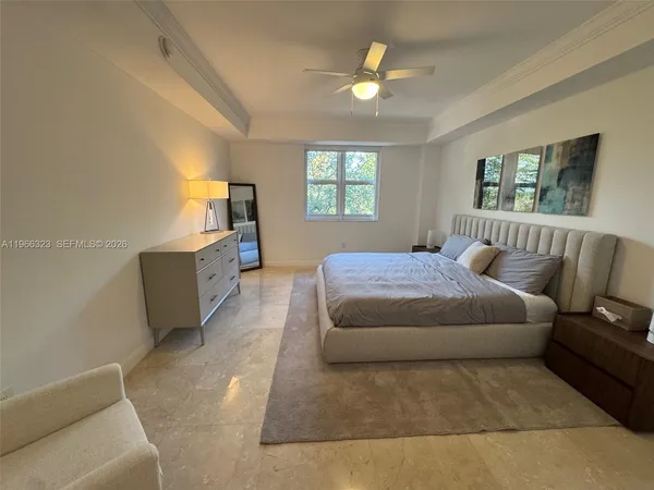 a spacious bedroom with a bed and window