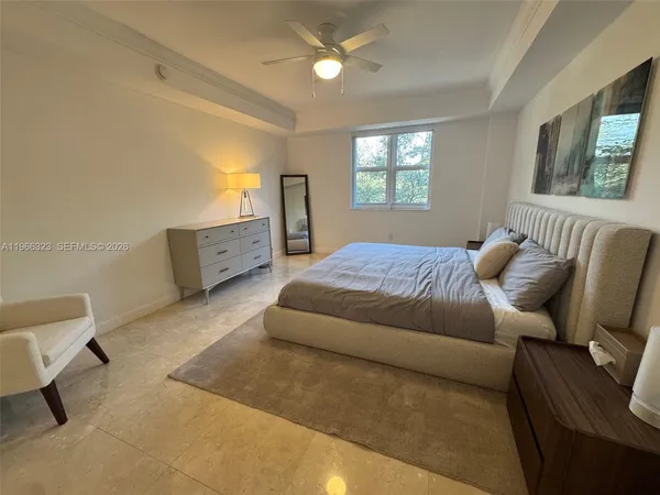 a spacious bedroom with a bed and window