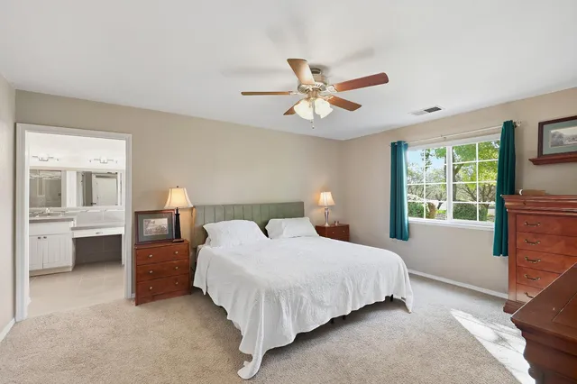 a bedroom with a bed and a table