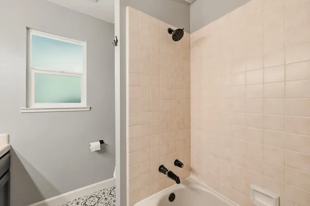 a bathroom with a bathtub and shower