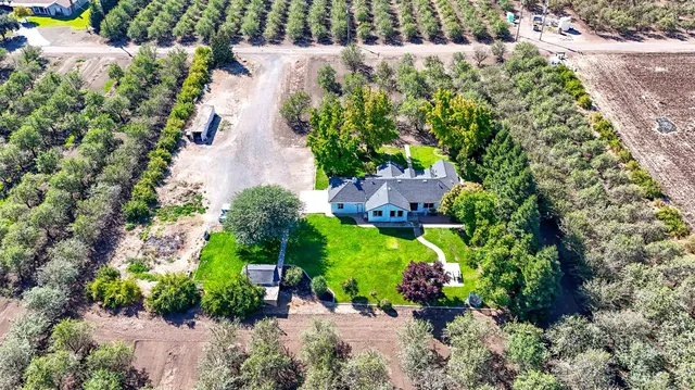 an aerial view of a house with a yard