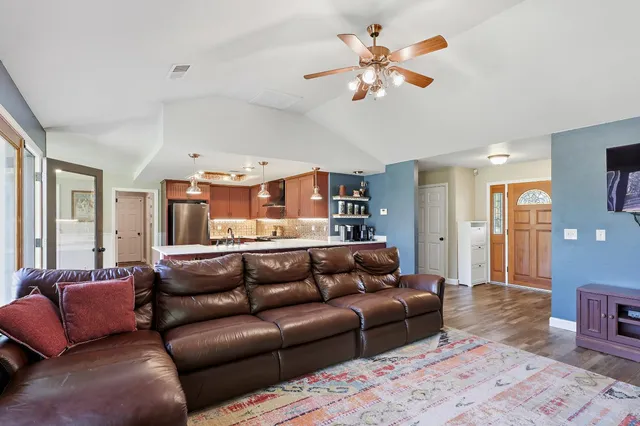 a living room with furniture and kitchen view