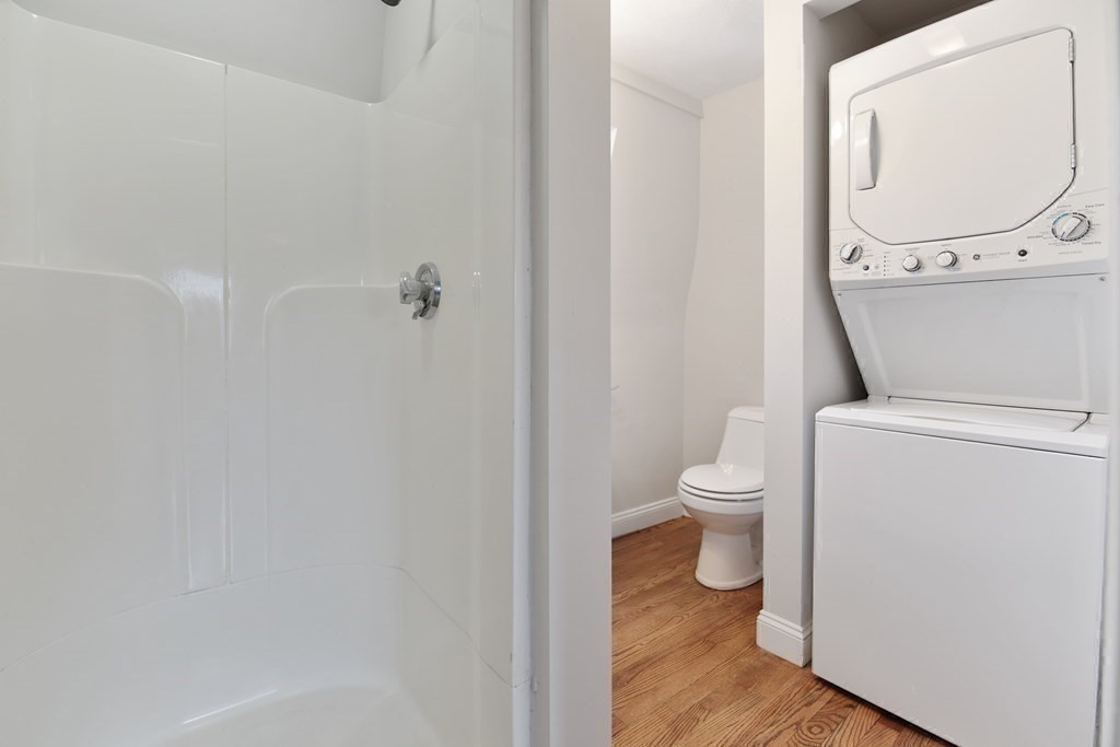23 Marcella Street, Unit 2 Boston, MA 02119 - Photo 12 of 26 a bathroom with a toilet and a mirror
