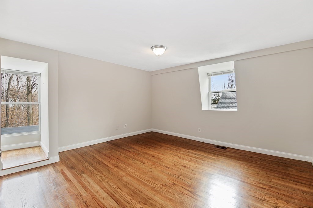 23 Marcella Street, Unit 2 Boston, MA 02119 - Photo 13 of 26 a view of empty room with wooden floor and fan