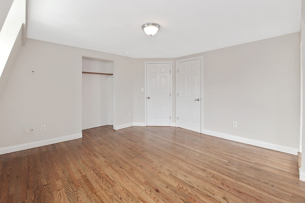 23 Marcella Street, Unit 2 Boston, MA 02119 - Photo 14 of 26 a view of an empty room with wooden floor