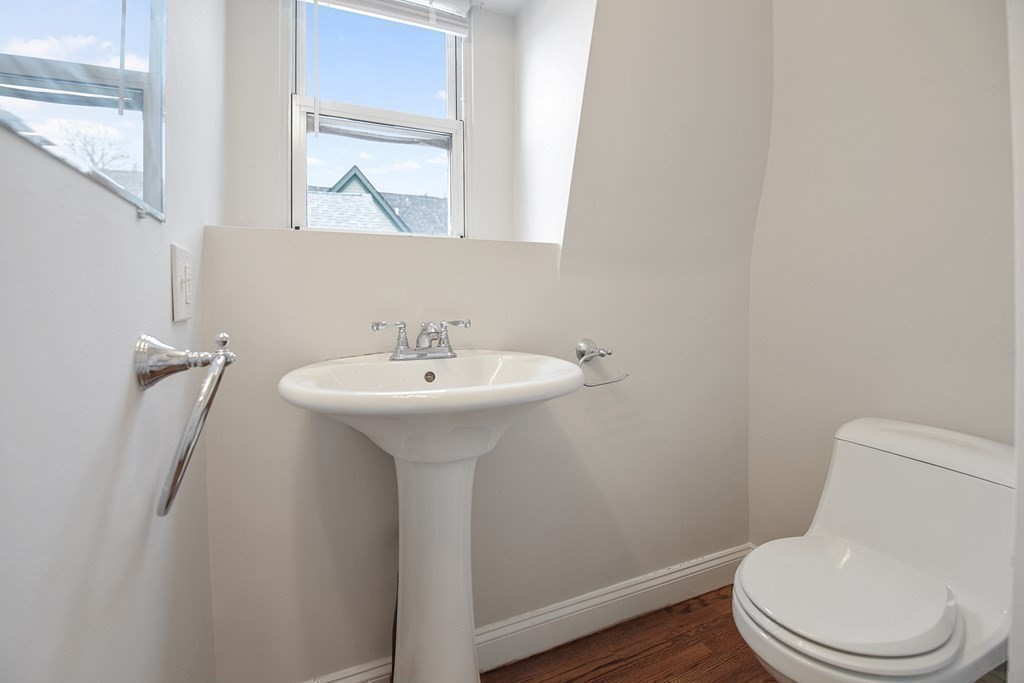23 Marcella Street, Unit 2 Boston, MA 02119 - Photo 15 of 26 a bathroom with a sink toilet and mirror