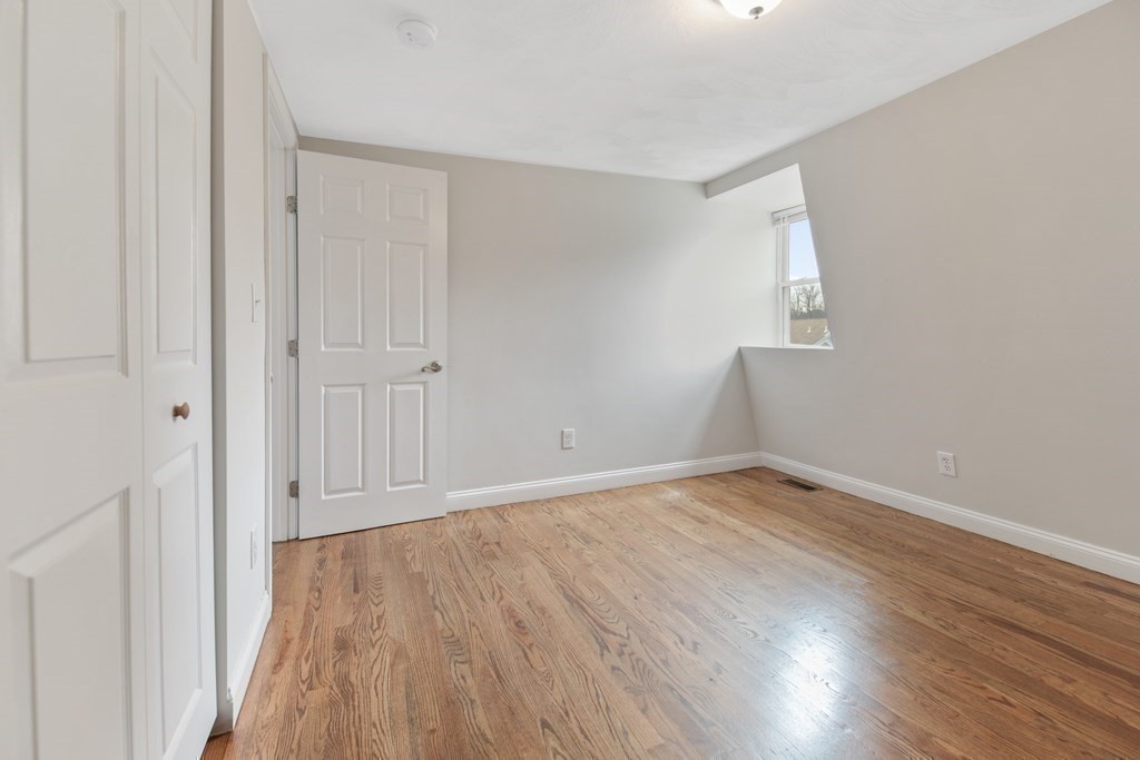 23 Marcella Street, Unit 2 Boston, MA 02119 - Photo 19 of 26 a view of an empty room with wooden floor