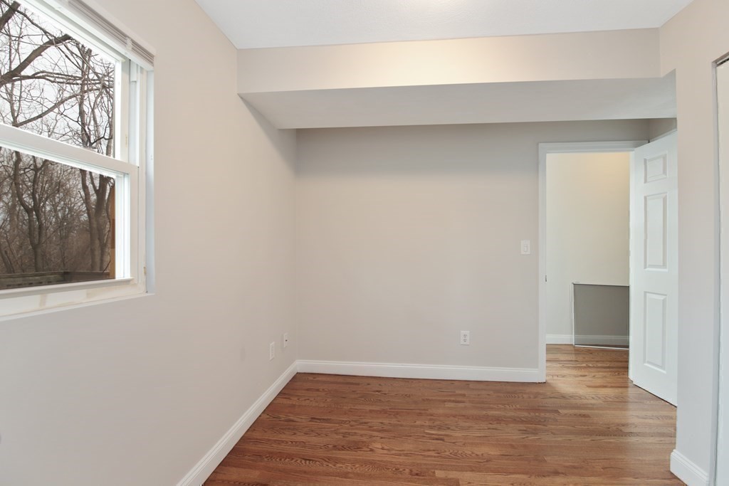 23 Marcella Street, Unit 2 Boston, MA 02119 - Photo 22 of 26 a view of an empty room with wooden floor and a window