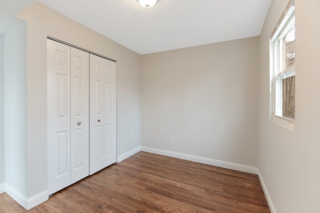 23 Marcella Street, Unit 2 Boston, MA 02119 - Photo 23 of 26 a view of an empty room with wooden floor and a window
