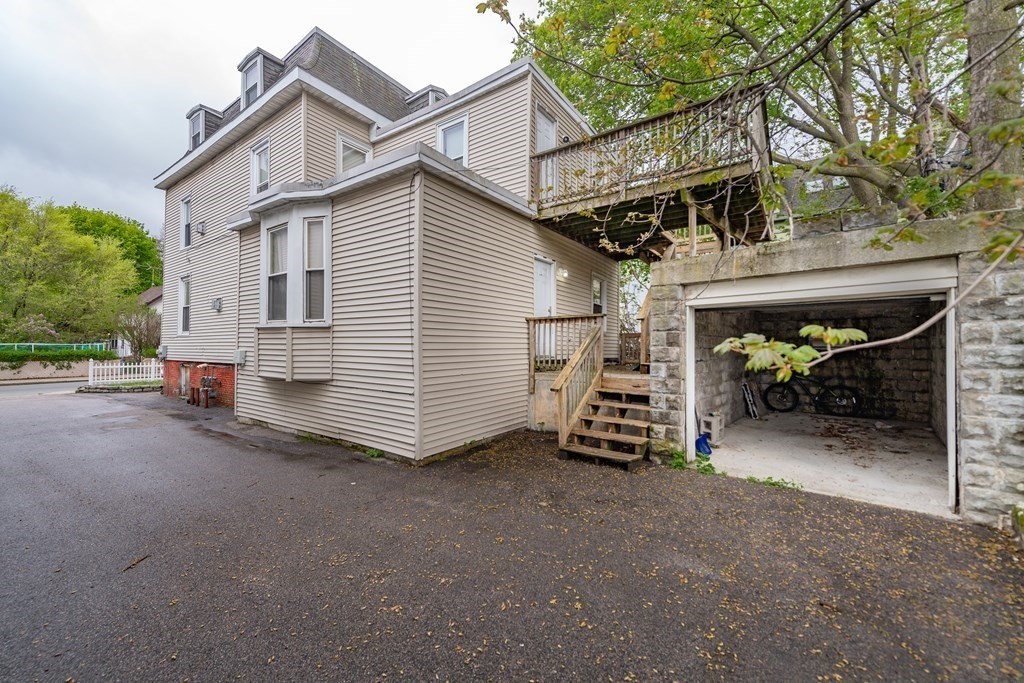 23 Marcella Street, Unit 2 Boston, MA 02119 - Photo 5 of 26 a view of a house with a yard and garage