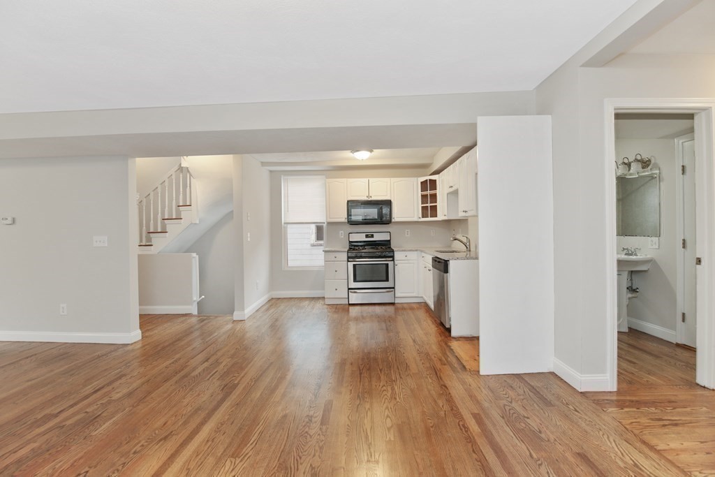23 Marcella Street, Unit 2 Boston, MA 02119 - Photo 9 of 26 a view of a kitchen with refrigerator and wooden floor