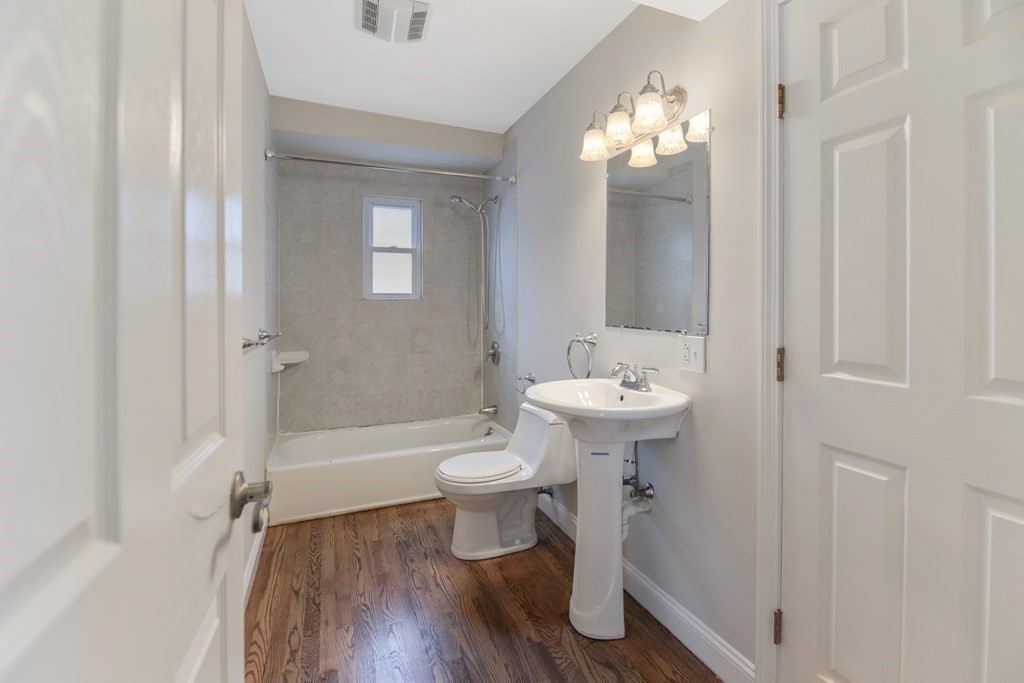23 Marcella Street, Unit 2 Boston, MA 02119 - Photo 10 of 26 a bathroom with a sink a toilet and shower
