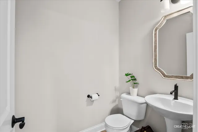 a white toilet sitting next to a bathroom sink
