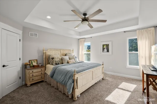 a bedroom with a large bed and a chandelier