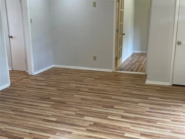 a view of wooden floor and closet in a room