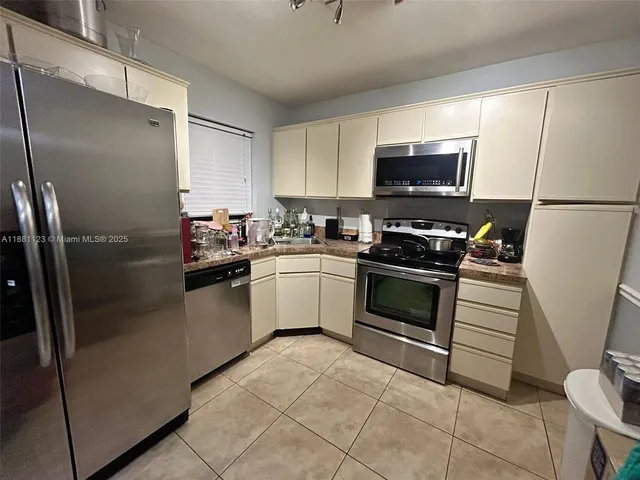 a kitchen with a refrigerator sink and microwave