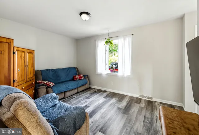 a living room with a couch and a window