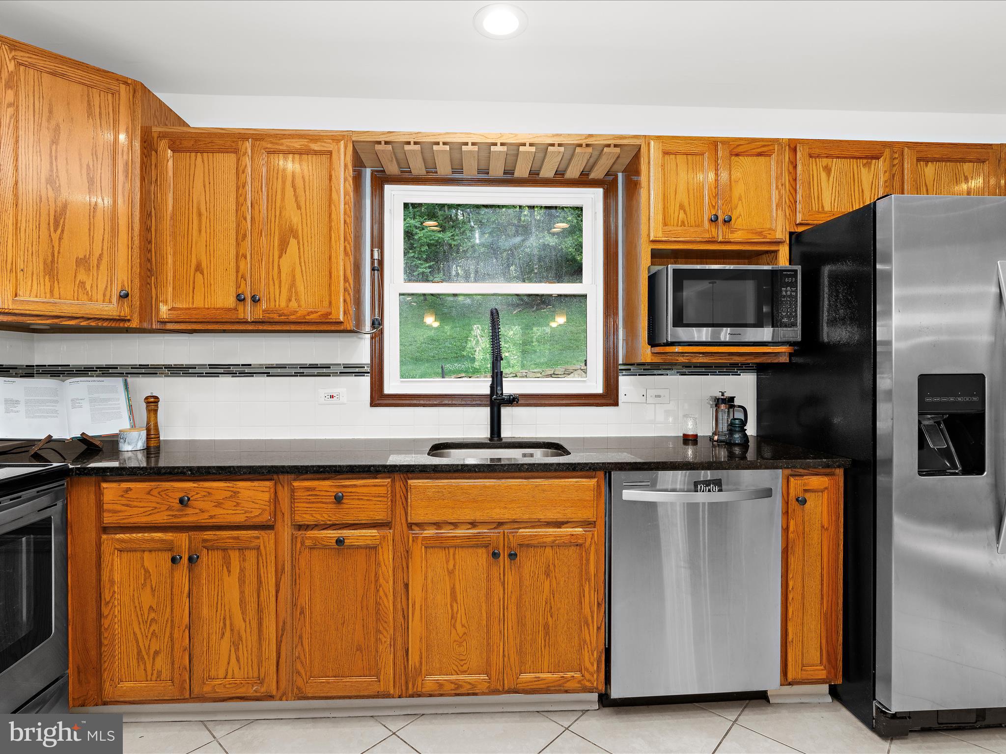 5306 Stone Road Frederick, MD 21703 - Photo 16 of 61 a kitchen with stainless steel appliances granite countertop a stove a sink and a microwave