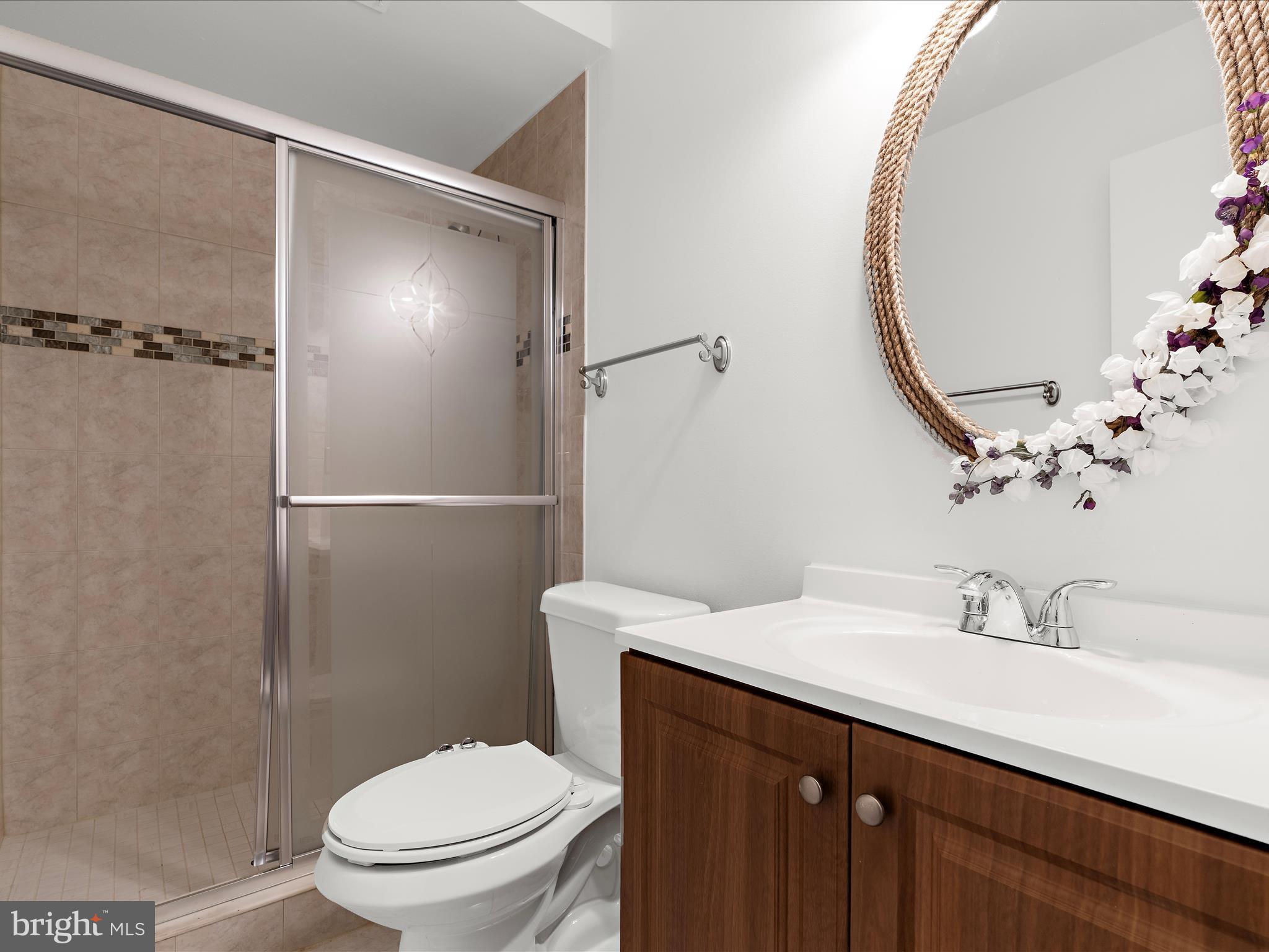 5306 Stone Road Frederick, MD 21703 - Photo 21 of 61 a bathroom with a sink a toilet and shower