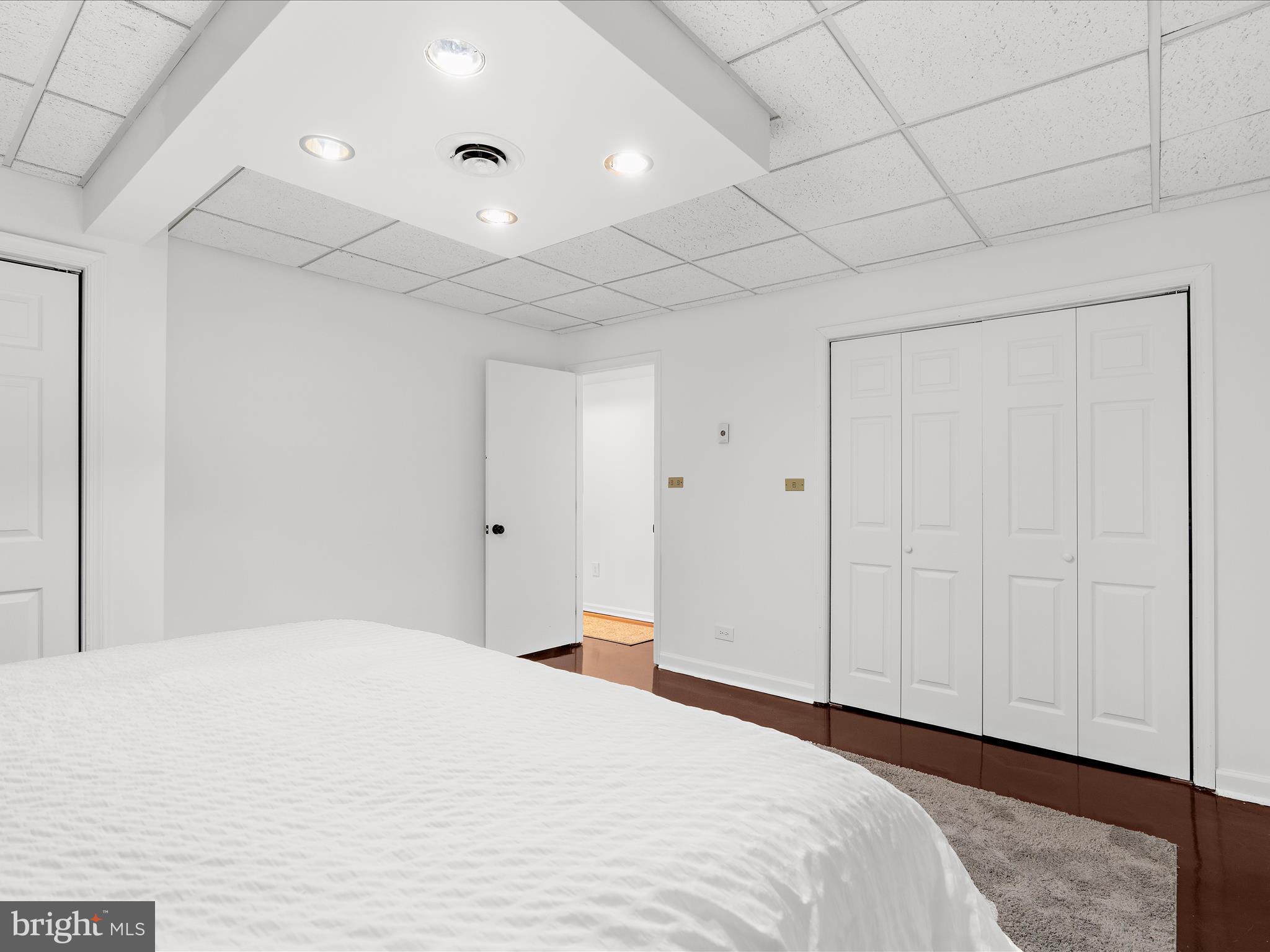 5306 Stone Road Frederick, MD 21703 - Photo 24 of 61 a bedroom with a large bed and a chandelier fan