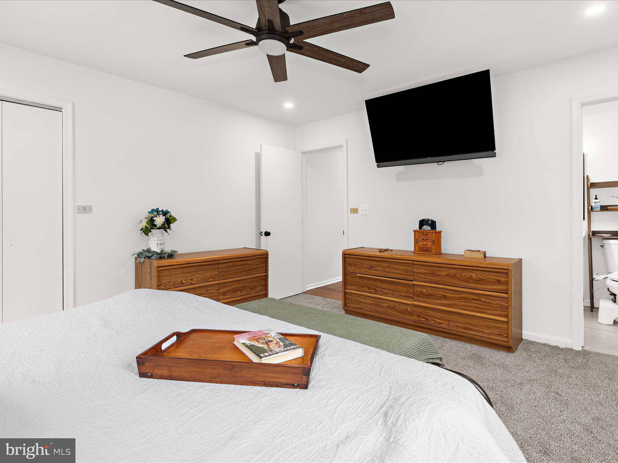 5306 Stone Road Frederick, MD 21703 - Photo 29 of 61 a bedroom with a bed and a flat screen tv