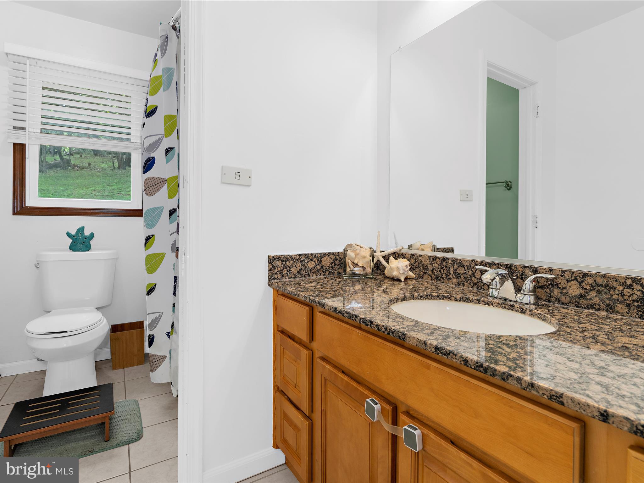 5306 Stone Road Frederick, MD 21703 - Photo 35 of 61 a bathroom with a granite countertop sink mirror vanity and toilet