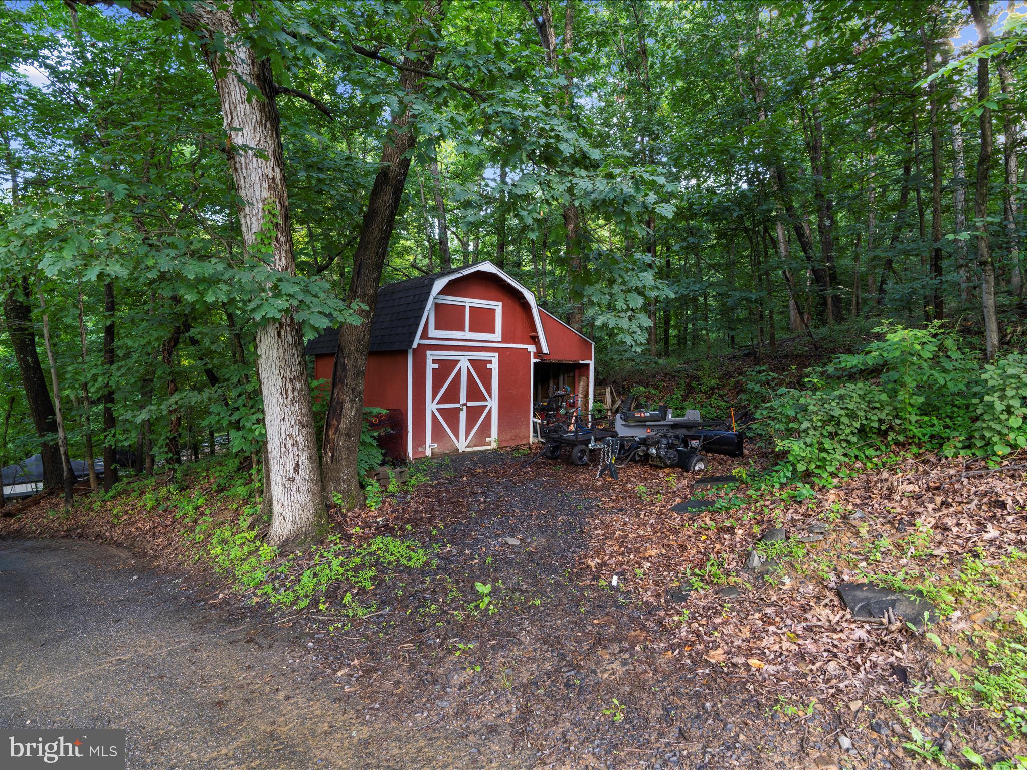 5306 Stone Road Frederick, MD 21703 - Photo 46 of 61 a view of a tiny house with a yard and large trees