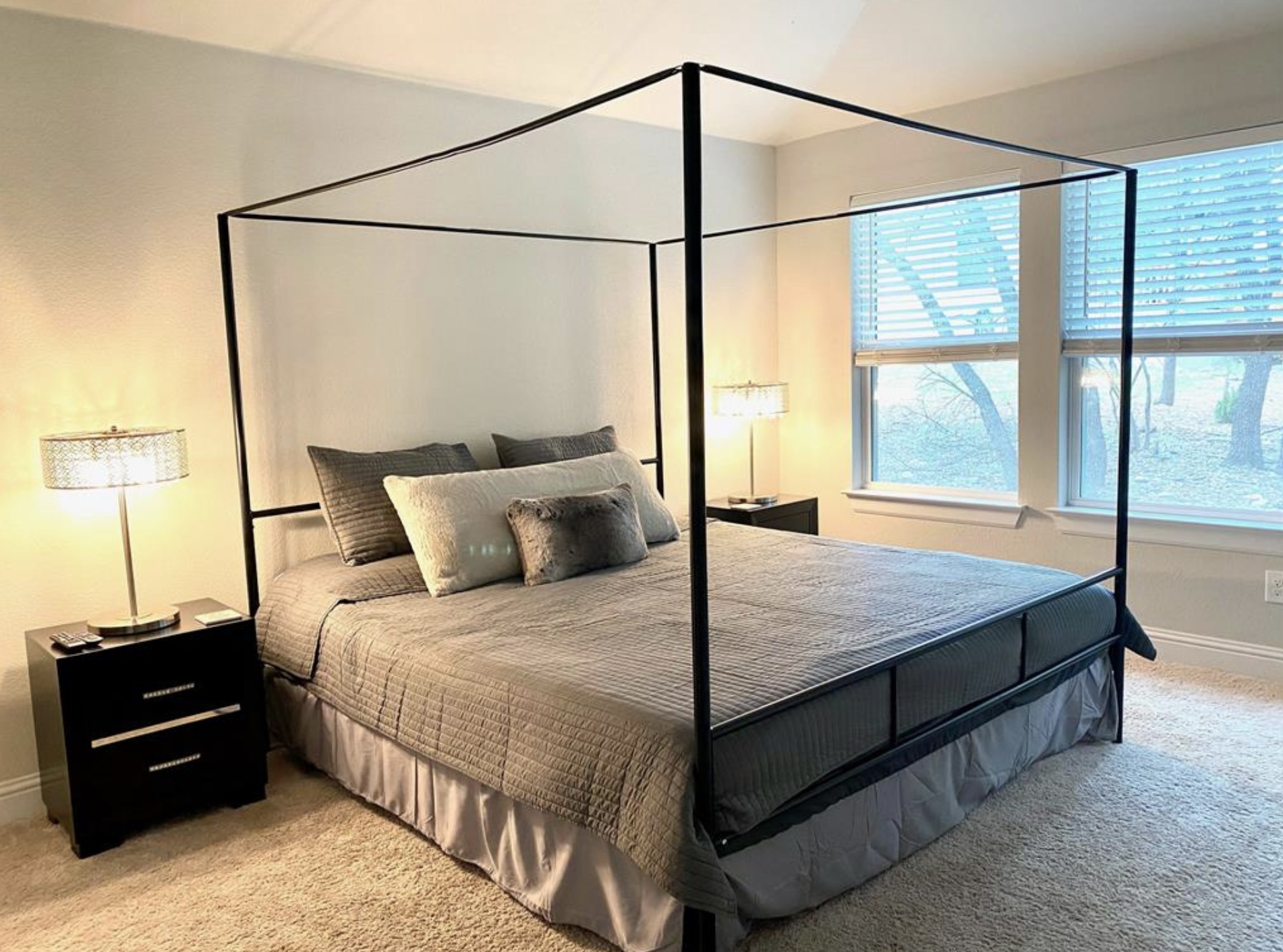 21643 Boggy Ford Road Lago Vista, TX 78645 - Photo 7 of 14 a bedroom with a bed and a night stand