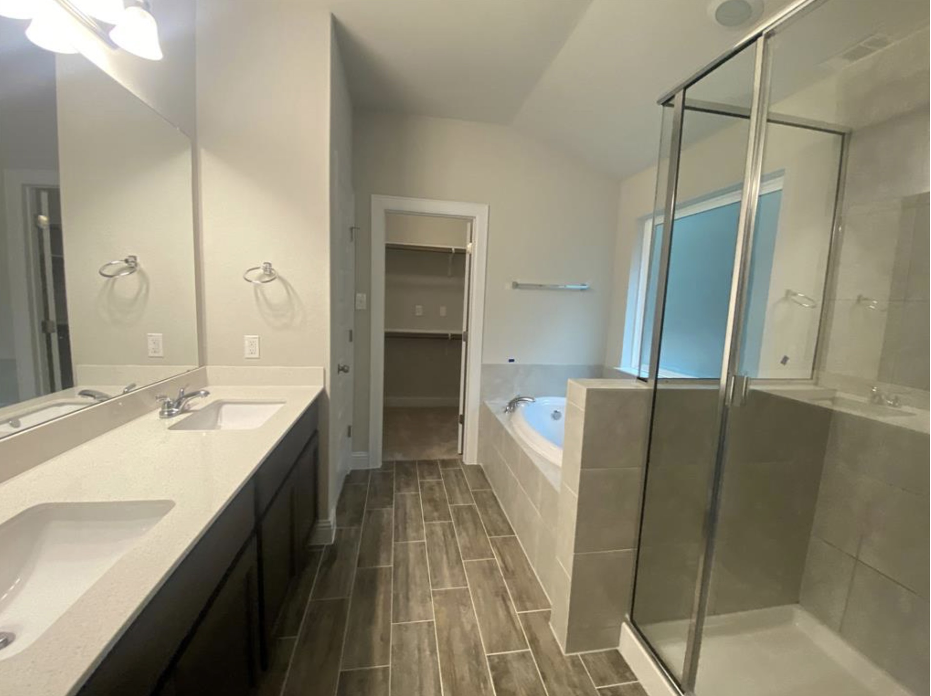21643 Boggy Ford Road Lago Vista, TX 78645 - Photo 8 of 14 a spacious bathroom with a double vanity sink a mirror and a bathtub