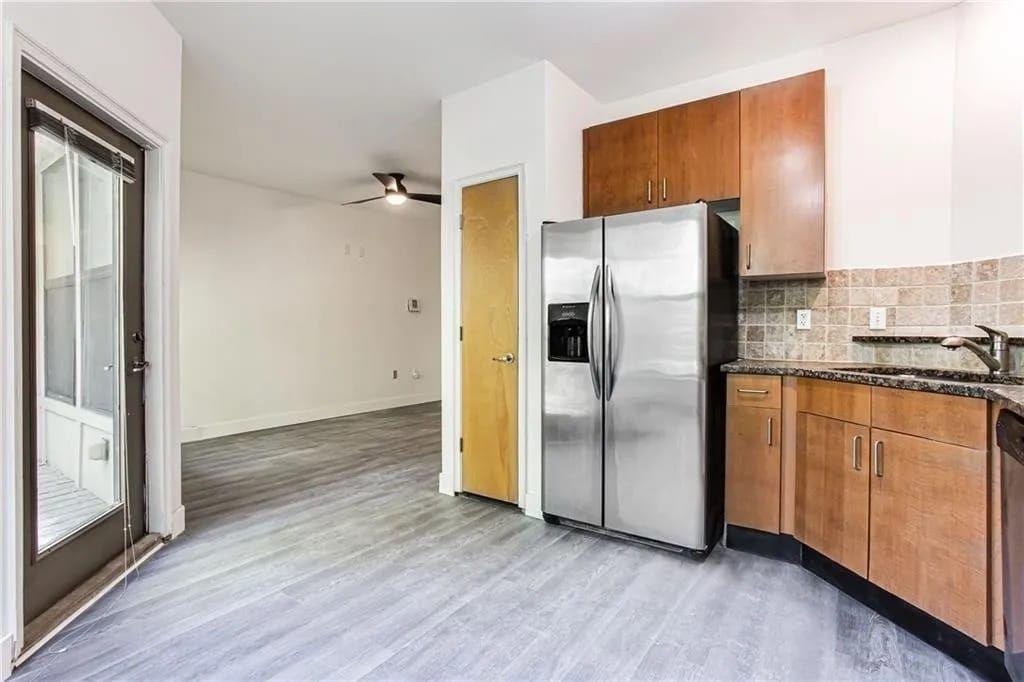 898 Oak Street Southwest, Unit 1307 Atlanta, GA 30310 - Photo 11 of 13 a kitchen with stainless steel appliances granite countertop a refrigerator and a stove top oven