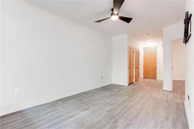 a view of an empty room with wooden floor