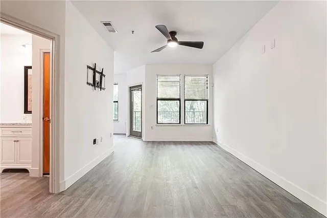 wooden floor in an empty room with a window