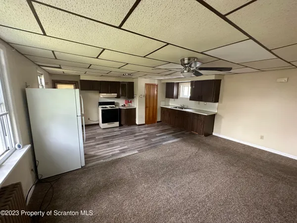 a view of a room with refrigerator and microwave