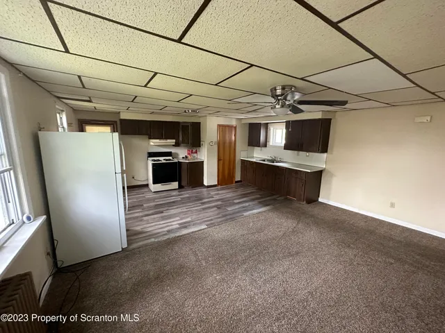 a view of a room with refrigerator and microwave