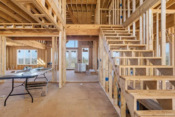 a living room with a furniture and a floor to ceiling window